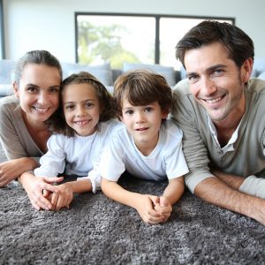 Family at home relaxing on carpet